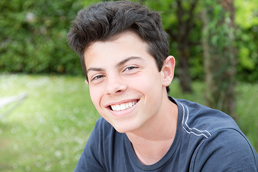 Teenage boy smiling at camera.